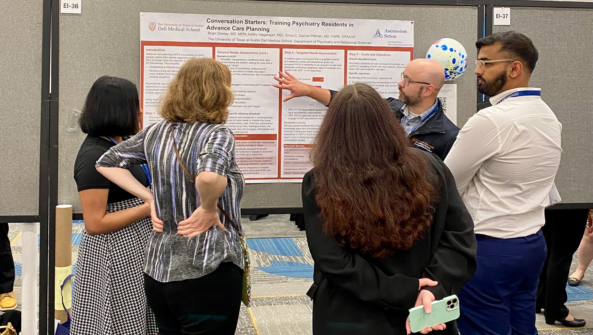 Members of the Geriatric Psychiatry Fellowship discuss a research poster.