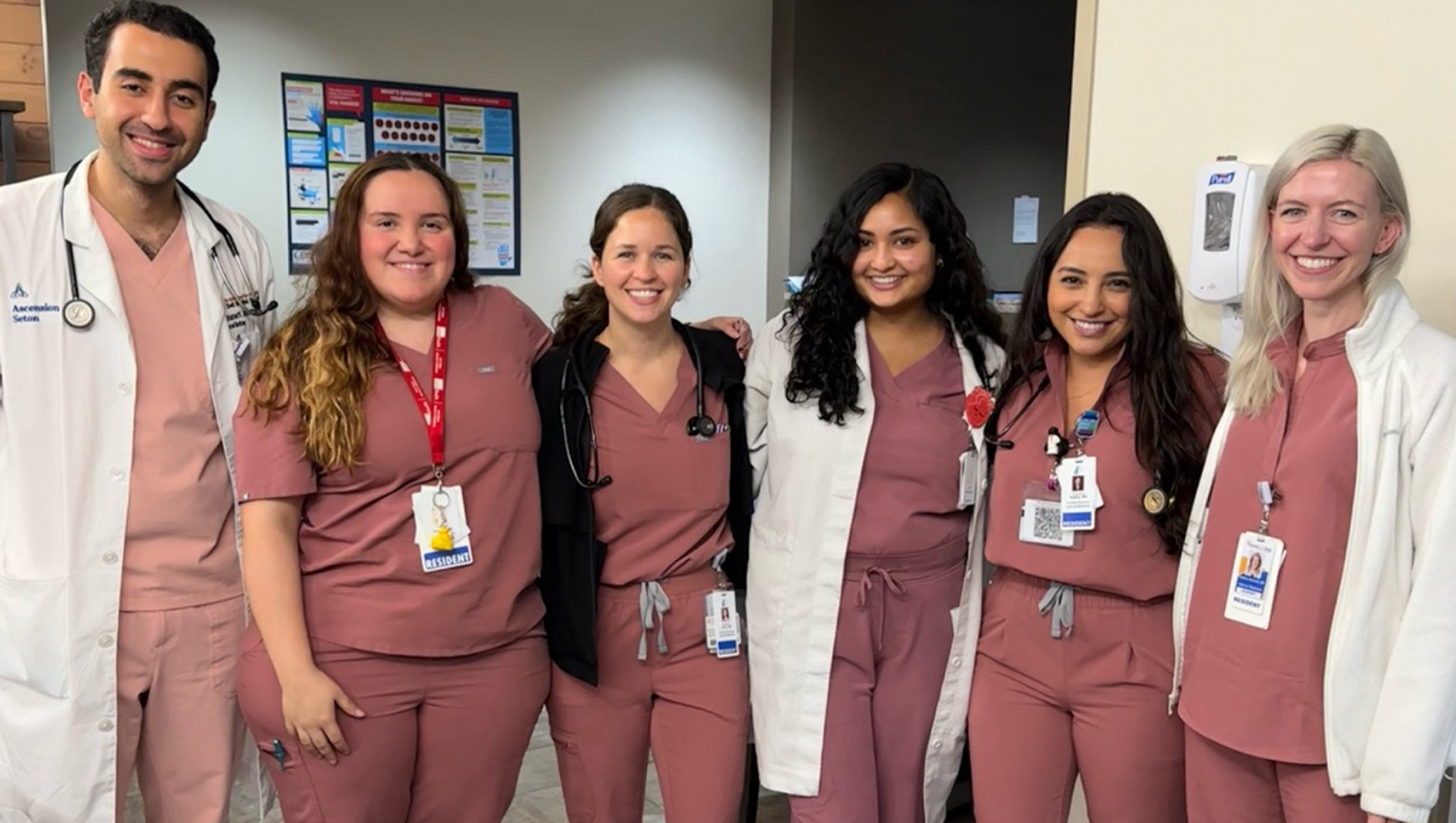 Group photo of internal medicine residents wearing pink scrubs.