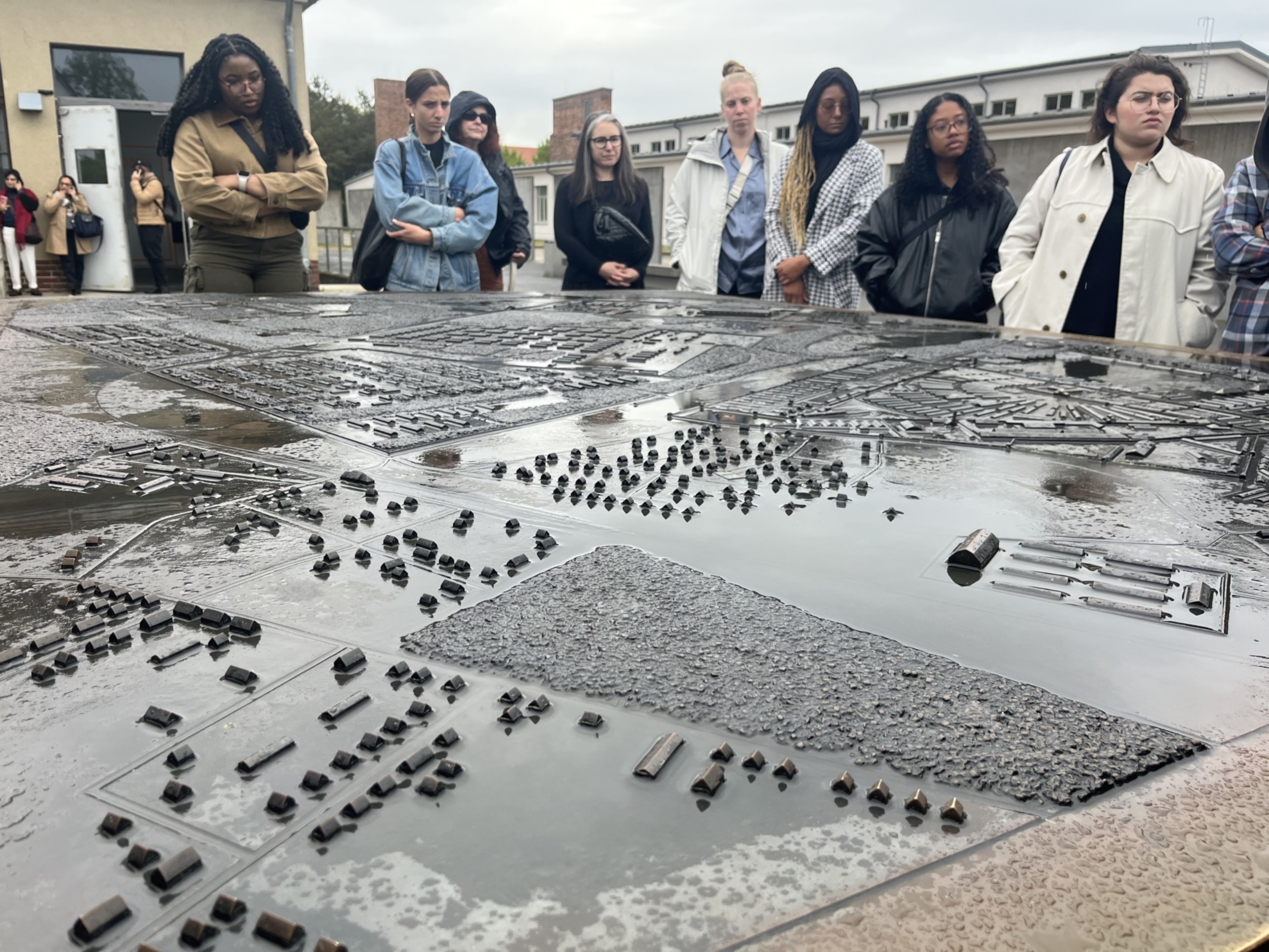 A group of Dell Medical School students observe a model installation of the Sachsenhausen concentration camp.