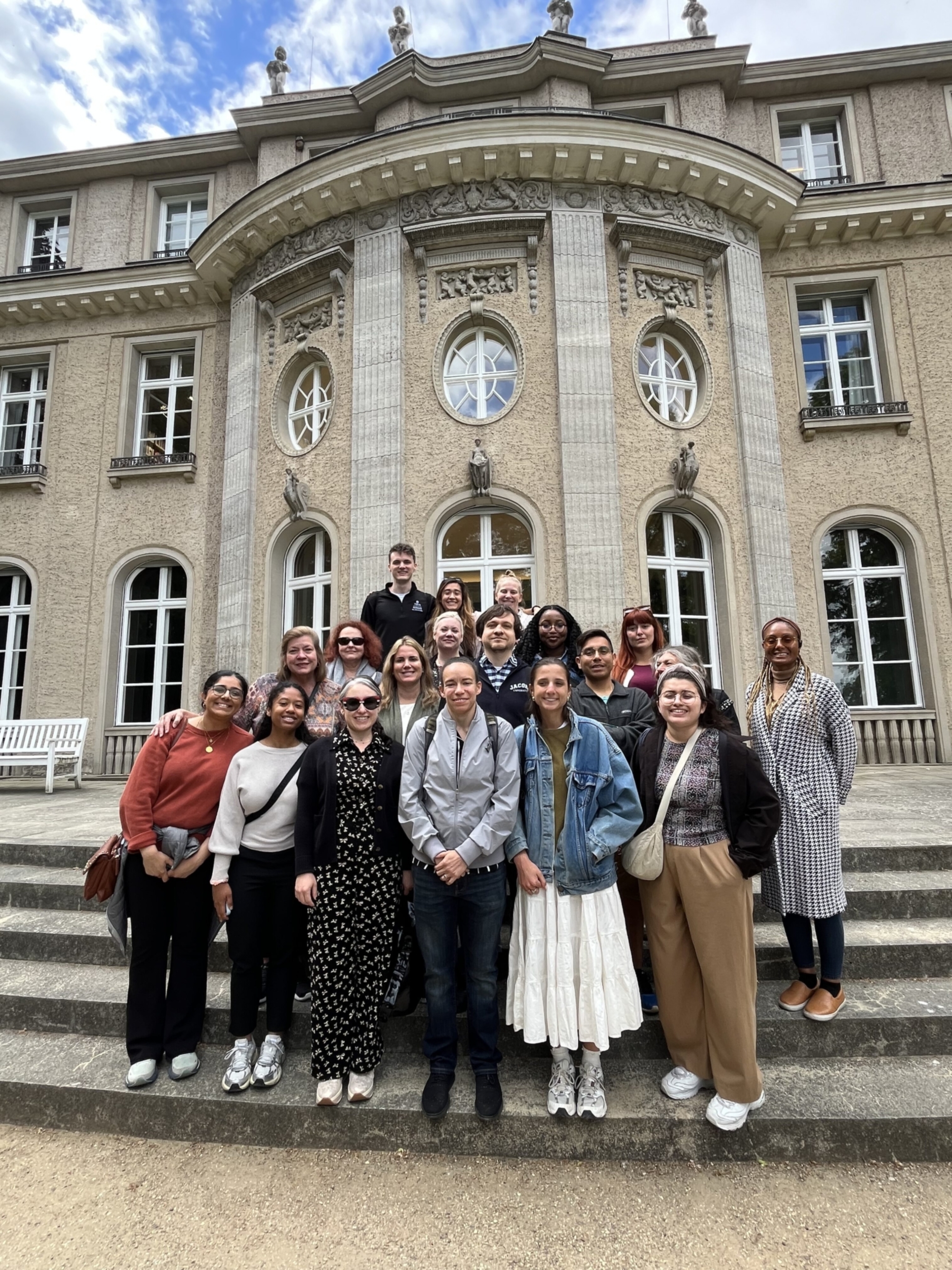 A group of Dell Medical School students stand for a portrait outside the building where the Wannsee Conference was held.